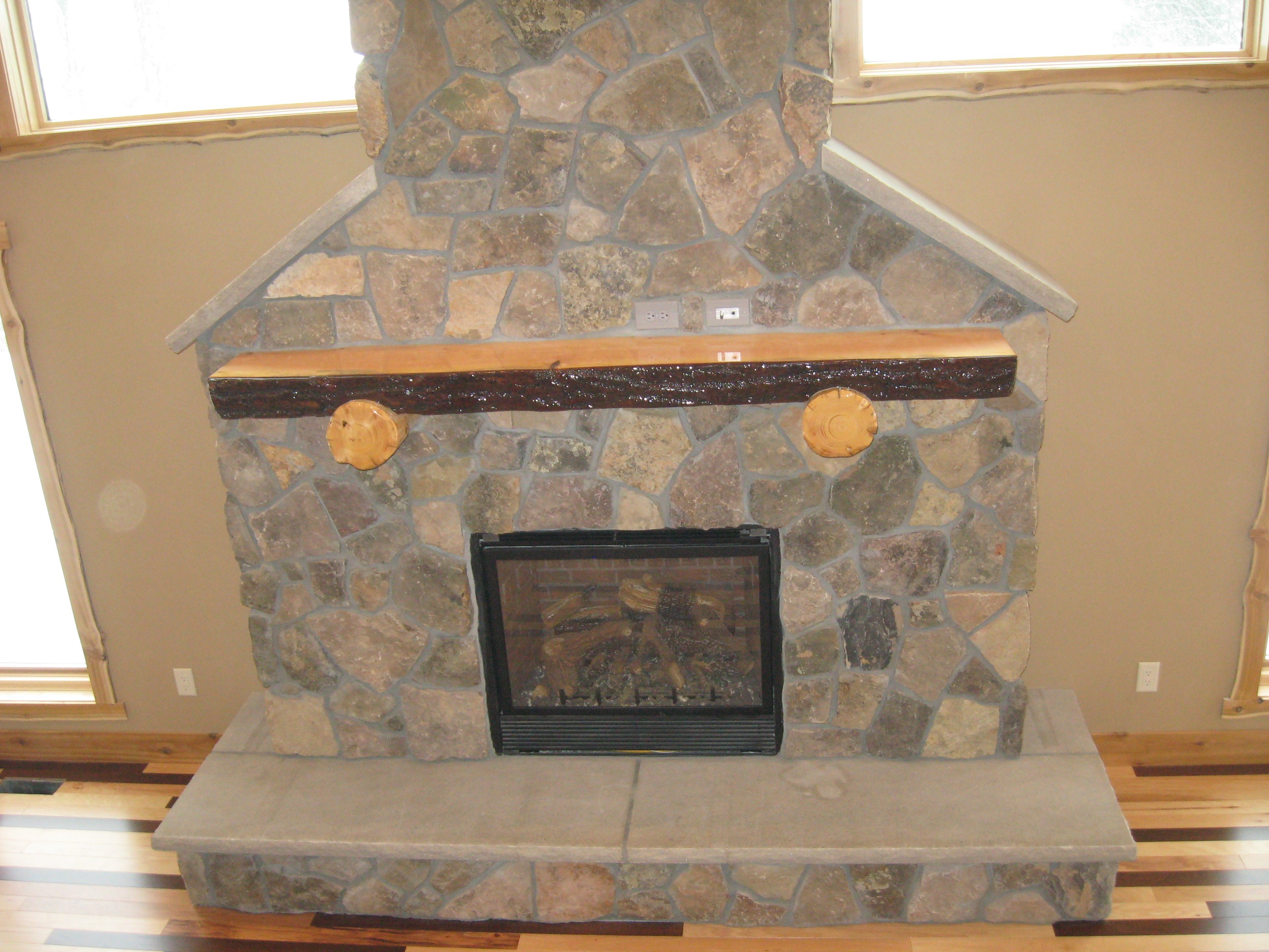 Natural log mantel over a fireplace