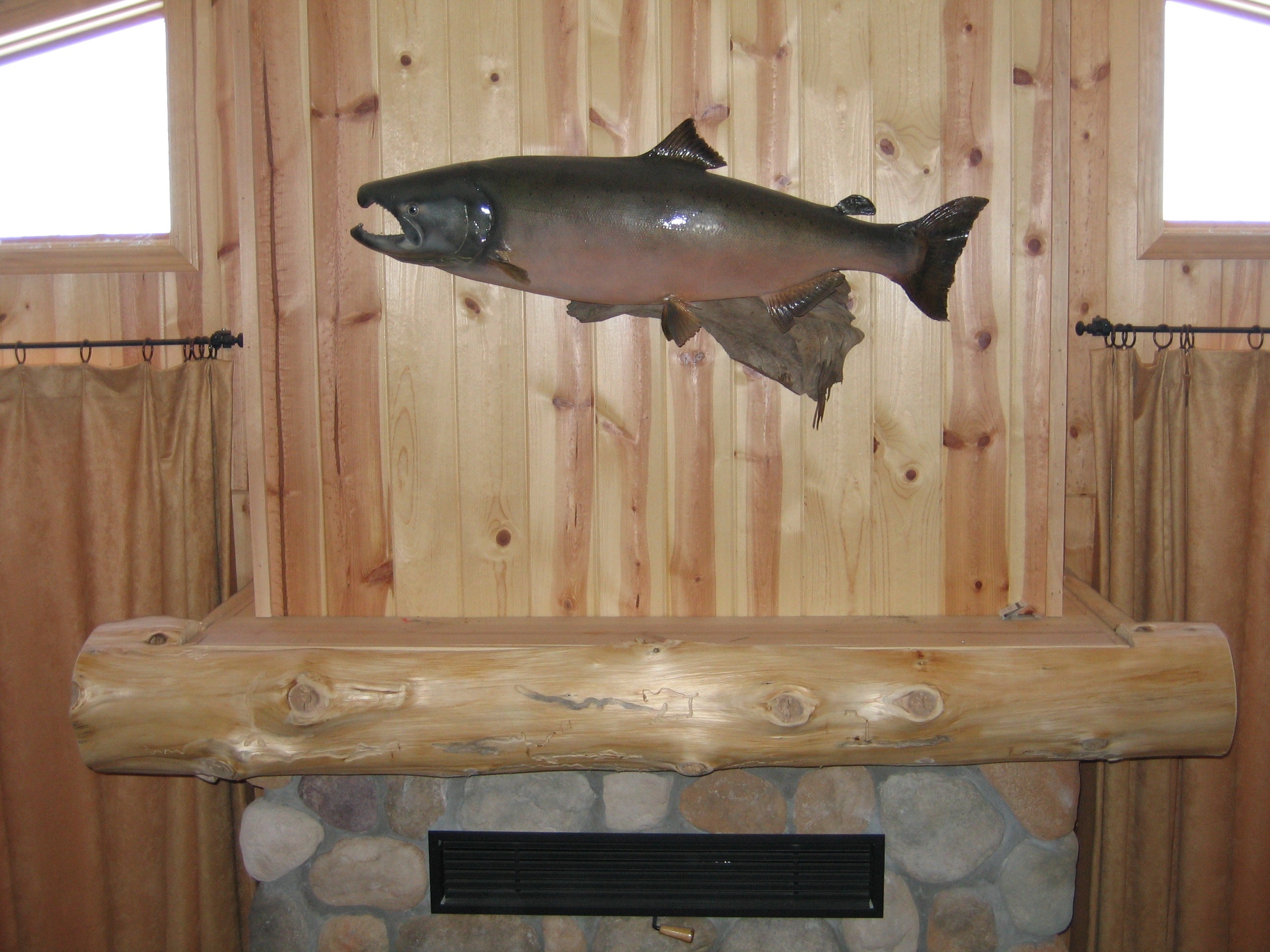 Natural mantel under a mounted salmon fish