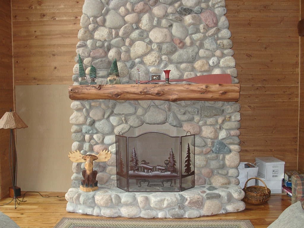 Natural timber mantel shelf over a fireplace