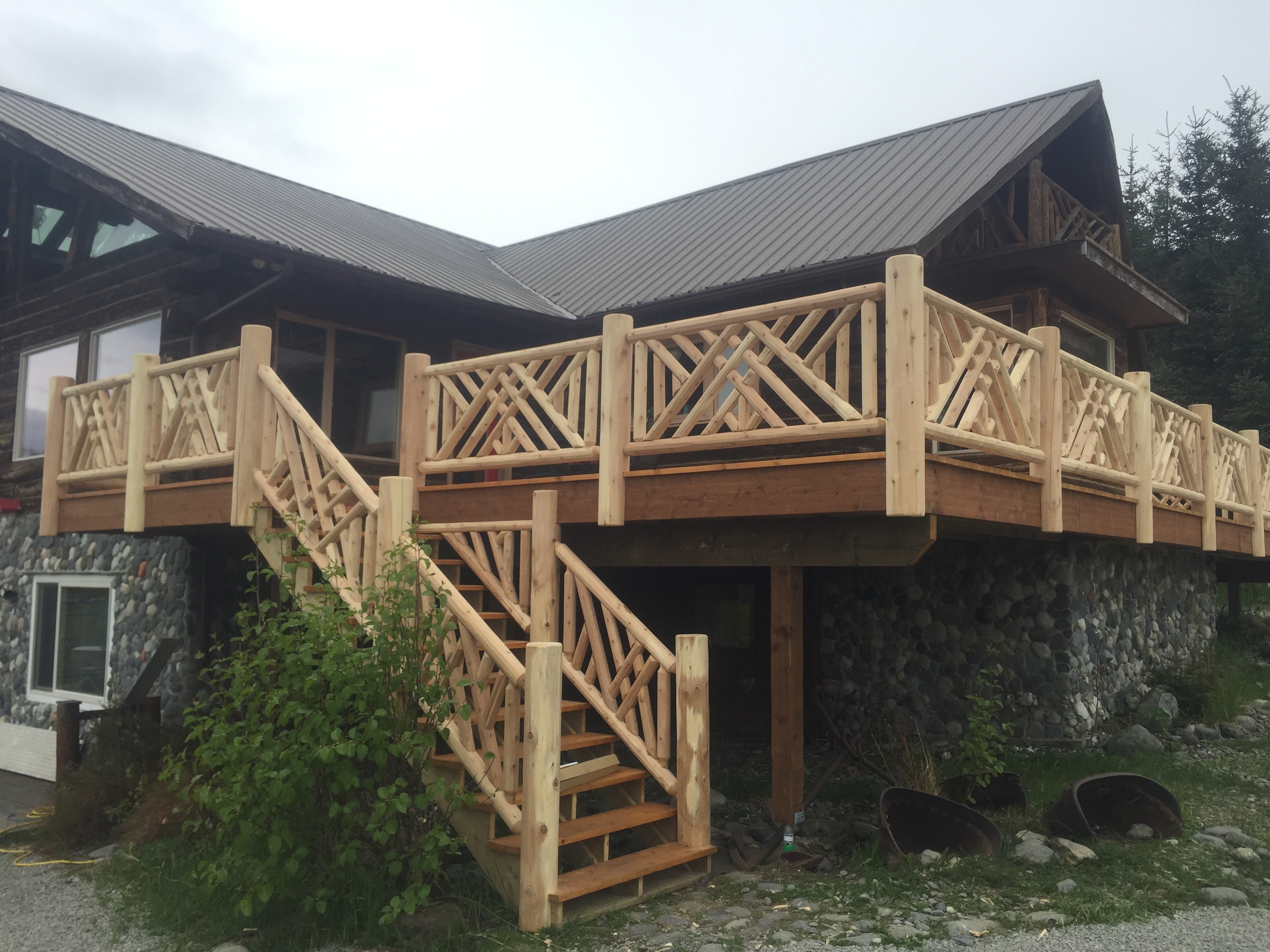 Custom log railing and stairs for outdoor deck in Home, Alaska