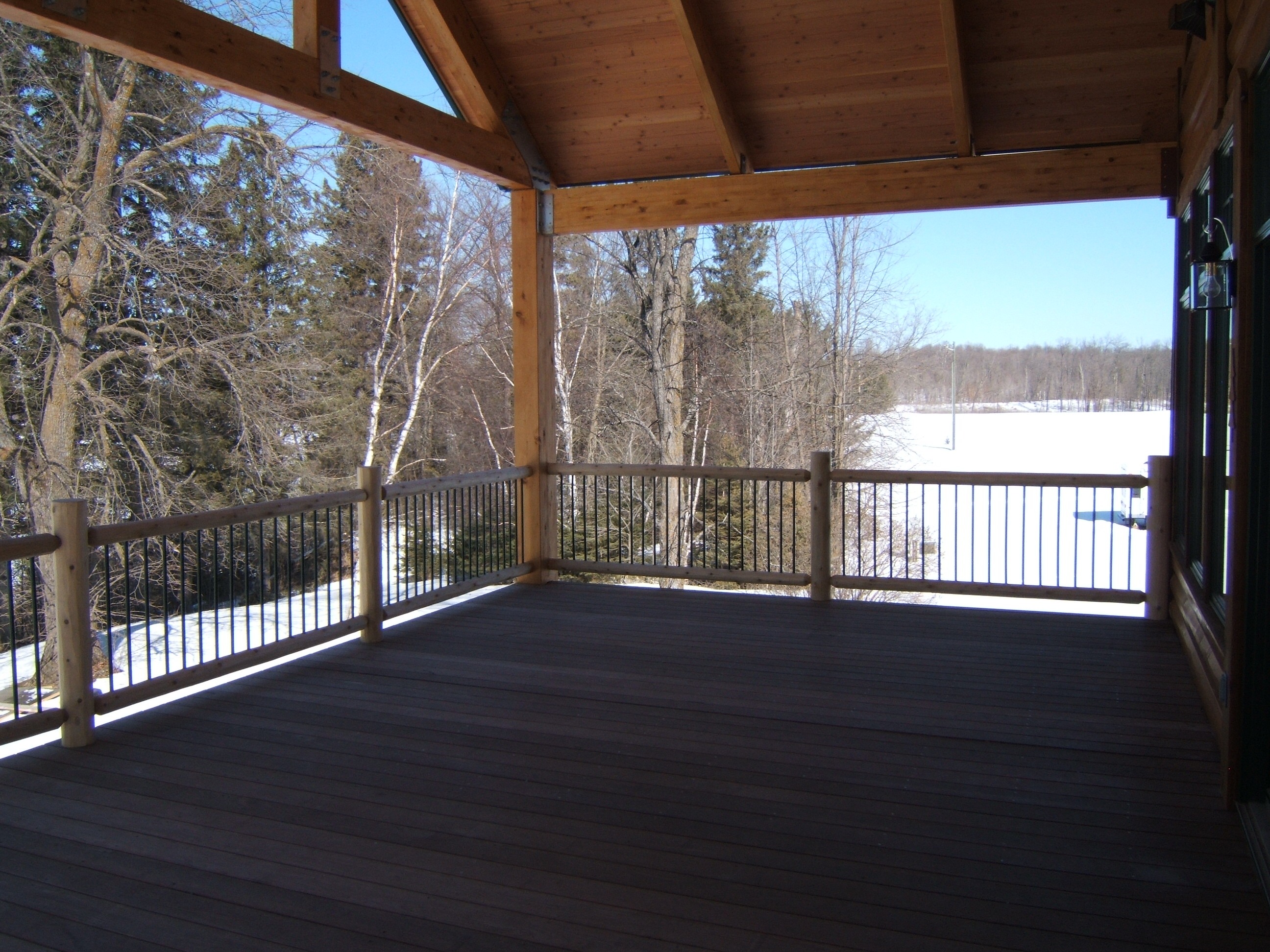 large wooden porch in winter | outdoor stair railings