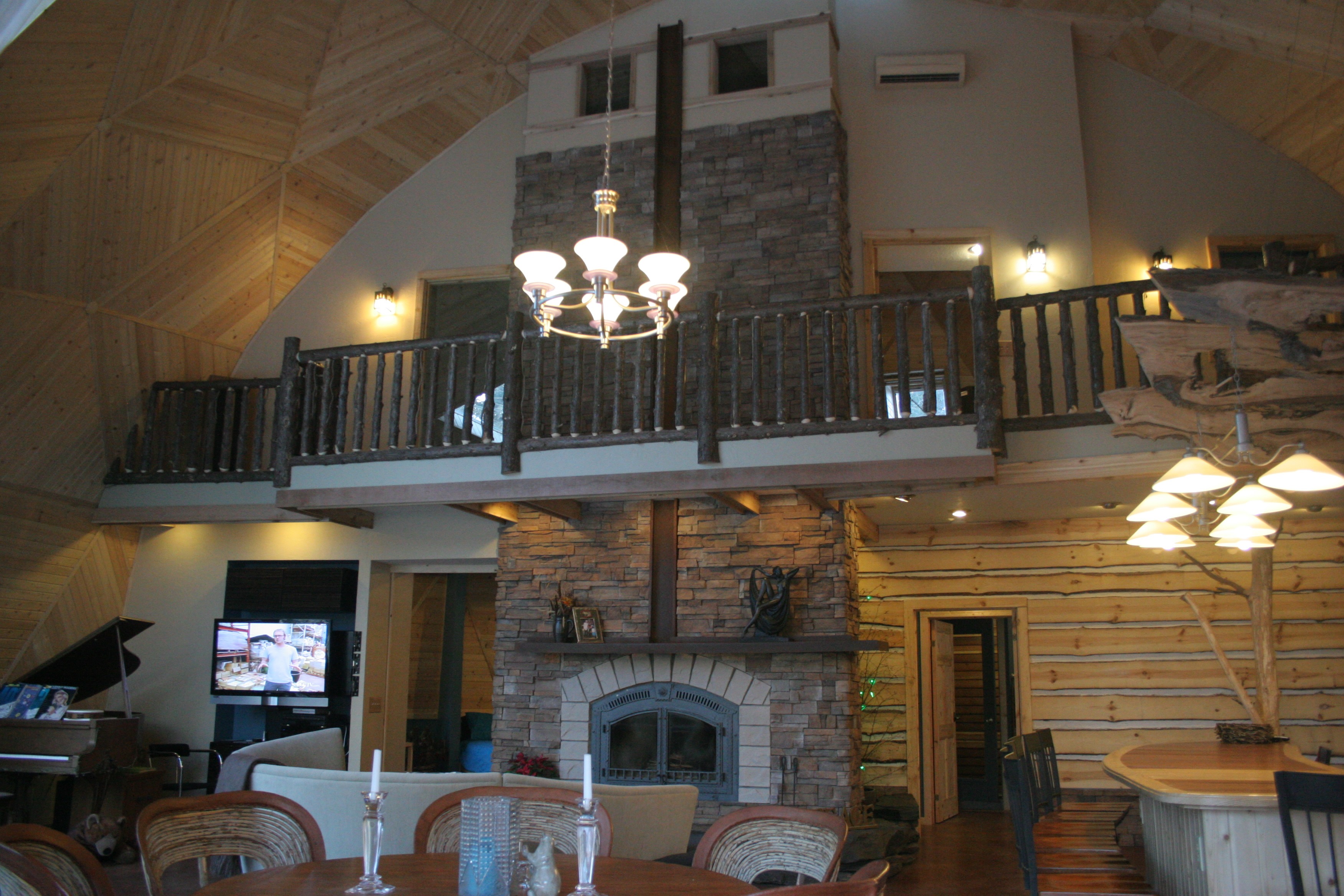 natural stone fireplace with natural timber railing | Wood Stair Railings